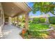 Inviting backyard with a covered patio, lush lawn, mature trees, and manicured landscaping, creating a serene outdoor space at 7411 Brittlethorne Ave, Las Vegas, NV 89131