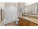 Bathroom featuring a granite countertop vanity, a bathtub with shower, and tile floors at 7411 Brittlethorne Ave, Las Vegas, NV 89131