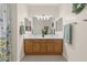 Large bathroom featuring double sinks, tile floors, and a bathtub with shower at 7411 Brittlethorne Ave, Las Vegas, NV 89131