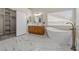 Stylish bathroom featuring a freestanding tub, double vanity, and walk-in closet at 7411 Brittlethorne Ave, Las Vegas, NV 89131