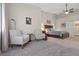 Large bedroom with a bed, seating area, and neutral decor at 7411 Brittlethorne Ave, Las Vegas, NV 89131