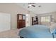 Open primary bedroom with large bed, dresser, and seating area at 7411 Brittlethorne Ave, Las Vegas, NV 89131