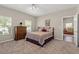 Cozy bedroom with carpet flooring, natural light, and traditional furniture at 7411 Brittlethorne Ave, Las Vegas, NV 89131