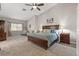 Primary bedroom with large bed, high ceilings, and plenty of natural light at 7411 Brittlethorne Ave, Las Vegas, NV 89131