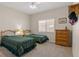 Cozy bedroom featuring two twin beds, neutral walls, and bright, natural light from the window at 7411 Brittlethorne Ave, Las Vegas, NV 89131