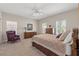 Well-lit bedroom features carpeted floors, a ceiling fan, and lots of natural light at 7411 Brittlethorne Ave, Las Vegas, NV 89131