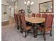 Traditional dining room featuring a large wooden table and chairs with decorative upholstery at 7411 Brittlethorne Ave, Las Vegas, NV 89131