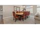 Elegant dining room with a grand mirror, chandelier, and seating for eight at 7411 Brittlethorne Ave, Las Vegas, NV 89131