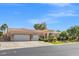 Spacious house with a three-car garage, desert landscaping, and a well-maintained exterior at 7411 Brittlethorne Ave, Las Vegas, NV 89131