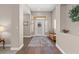 Inviting foyer featuring hardwood floors with neutral colored walls and a view to the entry door at 7411 Brittlethorne Ave, Las Vegas, NV 89131
