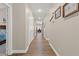 Hallway with hardwood floors, neutral walls, and views into the dining room at 7411 Brittlethorne Ave, Las Vegas, NV 89131