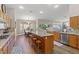 Spacious kitchen with granite counters, wood floors, a center island, and a breakfast nook dining area at 7411 Brittlethorne Ave, Las Vegas, NV 89131