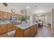 Bright kitchen with granite countertops, center island, wood floors, and stainless steel microwave at 7411 Brittlethorne Ave, Las Vegas, NV 89131