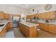 Well-appointed kitchen with granite countertops, wood cabinets, and stainless steel appliances at 7411 Brittlethorne Ave, Las Vegas, NV 89131