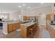 Spacious kitchen with a large island, stainless appliances, and hardwood floors at 7411 Brittlethorne Ave, Las Vegas, NV 89131