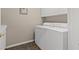 Laundry room featuring a tile floor, white cabinets, and a modern washer and dryer at 7411 Brittlethorne Ave, Las Vegas, NV 89131