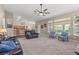 Spacious living room with a large window overlooking the backyard and an open floor plan at 7411 Brittlethorne Ave, Las Vegas, NV 89131