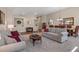Open-concept living room and dining room area featuring neutral tones and an abundance of natural light at 7411 Brittlethorne Ave, Las Vegas, NV 89131