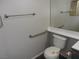 Bathroom featuring a toilet, towel racks, and a mirror above the vanity at 75 N Valle Verde Dr # 411, Henderson, NV 89074
