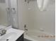 Bathroom featuring a white sink, and a white bathtub with white tile surround at 75 N Valle Verde Dr # 411, Henderson, NV 89074