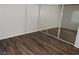 A bedroom featuring wood-look flooring and sliding mirror closet doors at 75 N Valle Verde Dr # 411, Henderson, NV 89074