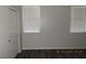 Bedroom with wood-look flooring, two windows and a closet with doors to the left at 75 N Valle Verde Dr # 411, Henderson, NV 89074