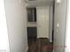 Hallway featuring wood-look flooring, a gray cabinet with open shelves, and a white door at 75 N Valle Verde Dr # 411, Henderson, NV 89074