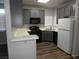 Modern kitchen with sleek gray cabinets and white appliances, offering a clean and functional space at 75 N Valle Verde Dr # 411, Henderson, NV 89074