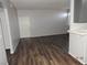 Spacious living room with wood flooring, neutral walls, and ample natural light at 75 N Valle Verde Dr # 411, Henderson, NV 89074