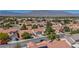 Neighborhood featuring neatly arranged homes with red tile roofs, mature trees, and scenic mountain views in the distance at 7824 Faith Ct, Las Vegas, NV 89131