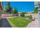 Cozy backyard with small lawn area, patio and fenced in dog run at 7824 Faith Ct, Las Vegas, NV 89131