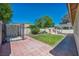 Fenced backyard features a patio, grassy area and side yard dog run at 7824 Faith Ct, Las Vegas, NV 89131