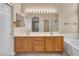 Bathroom featuring double sinks and expansive mirror and ample lighting at 7824 Faith Ct, Las Vegas, NV 89131