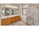 Bathroom featuring a double sink vanity and separate shower and tub at 7824 Faith Ct, Las Vegas, NV 89131