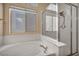 A soaking tub beneath a bright window provides a relaxing bathing experience at 7824 Faith Ct, Las Vegas, NV 89131