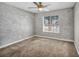 This bedroom is illuminated by natural light, has neutral paint, and carpeted floors at 7824 Faith Ct, Las Vegas, NV 89131