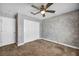 This bedroom features neutral paint, carpeted floors, a ceiling fan, and two closets at 7824 Faith Ct, Las Vegas, NV 89131