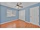 Well-lit bedroom features a ceiling fan and closet for storage at 7824 Faith Ct, Las Vegas, NV 89131