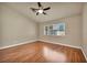 Minimal bedroom features wood floors, a ceiling fan and a window at 7824 Faith Ct, Las Vegas, NV 89131