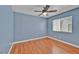 This bedroom has wood floors, baseboard trim, and a large window for natural light at 7824 Faith Ct, Las Vegas, NV 89131