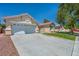 Exterior view of a well-maintained single-story house with a spacious driveway and xeriscaping in the yard at 7824 Faith Ct, Las Vegas, NV 89131