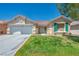 Charming single-story home featuring desert landscaping, a spacious lawn, and a two car garage at 7824 Faith Ct, Las Vegas, NV 89131
