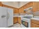 Bright kitchen featuring white appliances, white backsplash and tile floors at 7824 Faith Ct, Las Vegas, NV 89131