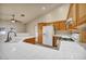 Bright kitchen featuring wooden cabinets, white appliances and tile floors at 7824 Faith Ct, Las Vegas, NV 89131