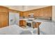 Bright kitchen features white appliances, white backsplash, wooden cabinets and tile floors at 7824 Faith Ct, Las Vegas, NV 89131
