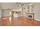 Spacious living room with hardwood floors, ceiling fans, and a cozy fireplace at 7824 Faith Ct, Las Vegas, NV 89131