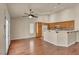 Bright living room features wood floors, a ceiling fan, and an open layout with kitchen access at 7824 Faith Ct, Las Vegas, NV 89131