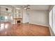 Bright living area featuring a fireplace, hardwood floors, and large windows at 7824 Faith Ct, Las Vegas, NV 89131