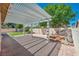Open patio featuring brick flooring, landscaped garden and shaded pergola at 7824 Faith Ct, Las Vegas, NV 89131