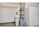 This utility room features a water heater, water softener, and storage cabinets at 7824 Faith Ct, Las Vegas, NV 89131